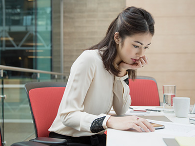 Woman working at conference room table.