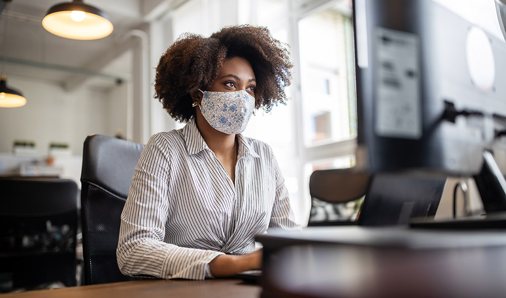 Woman working with mask on.