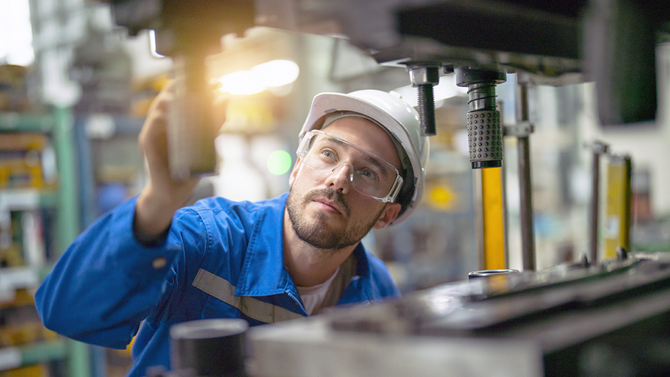 Man inspecting a manufacturing breakdown.