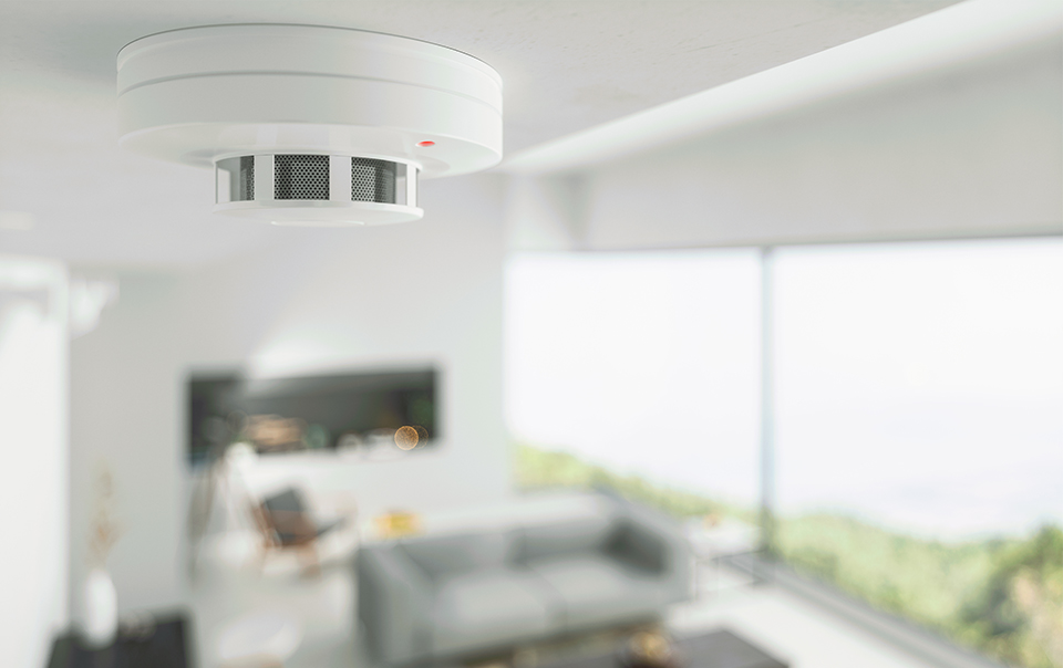 Image of fire detector on ceiling of a home.