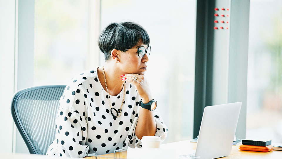 Business woman looking at laptop.