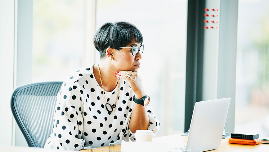 Business woman looking at laptop.