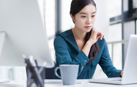 Woman looking at laptop.