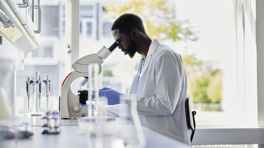 scientist looking into a microscope