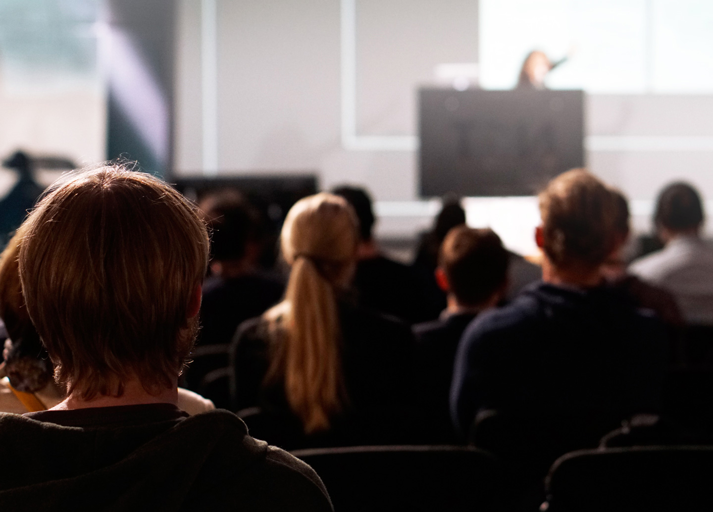 Audience members engaged in a presentation.