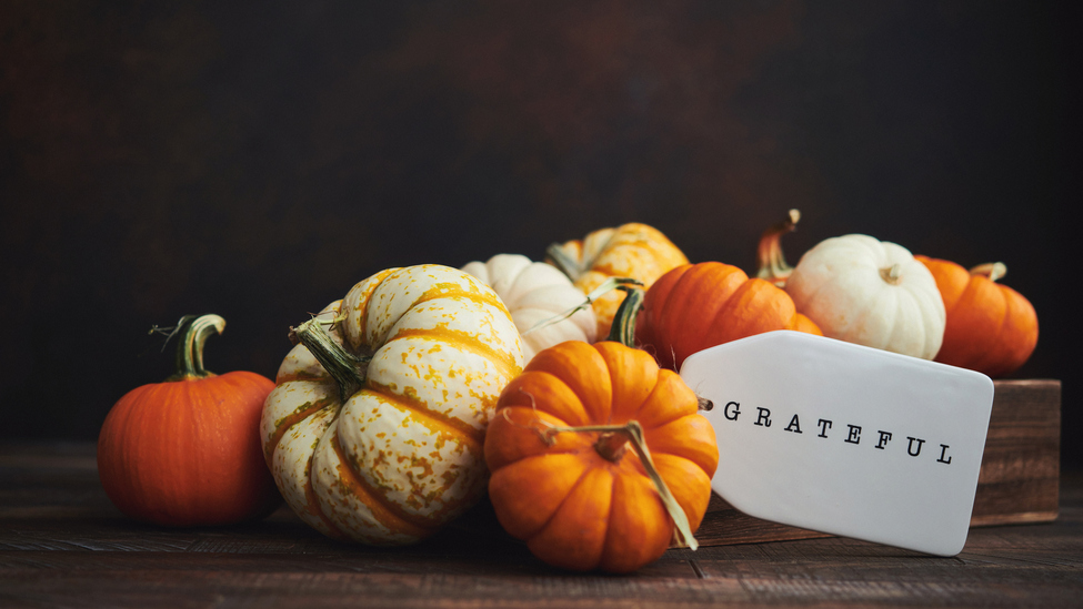 Thanksgiving decor with pumpkins and a notecard saying grateful