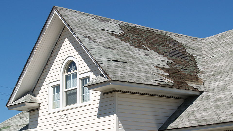 White house with a damaged roof