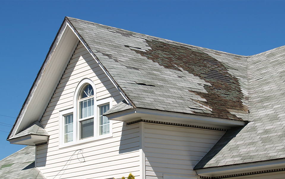 White house with a damaged roof