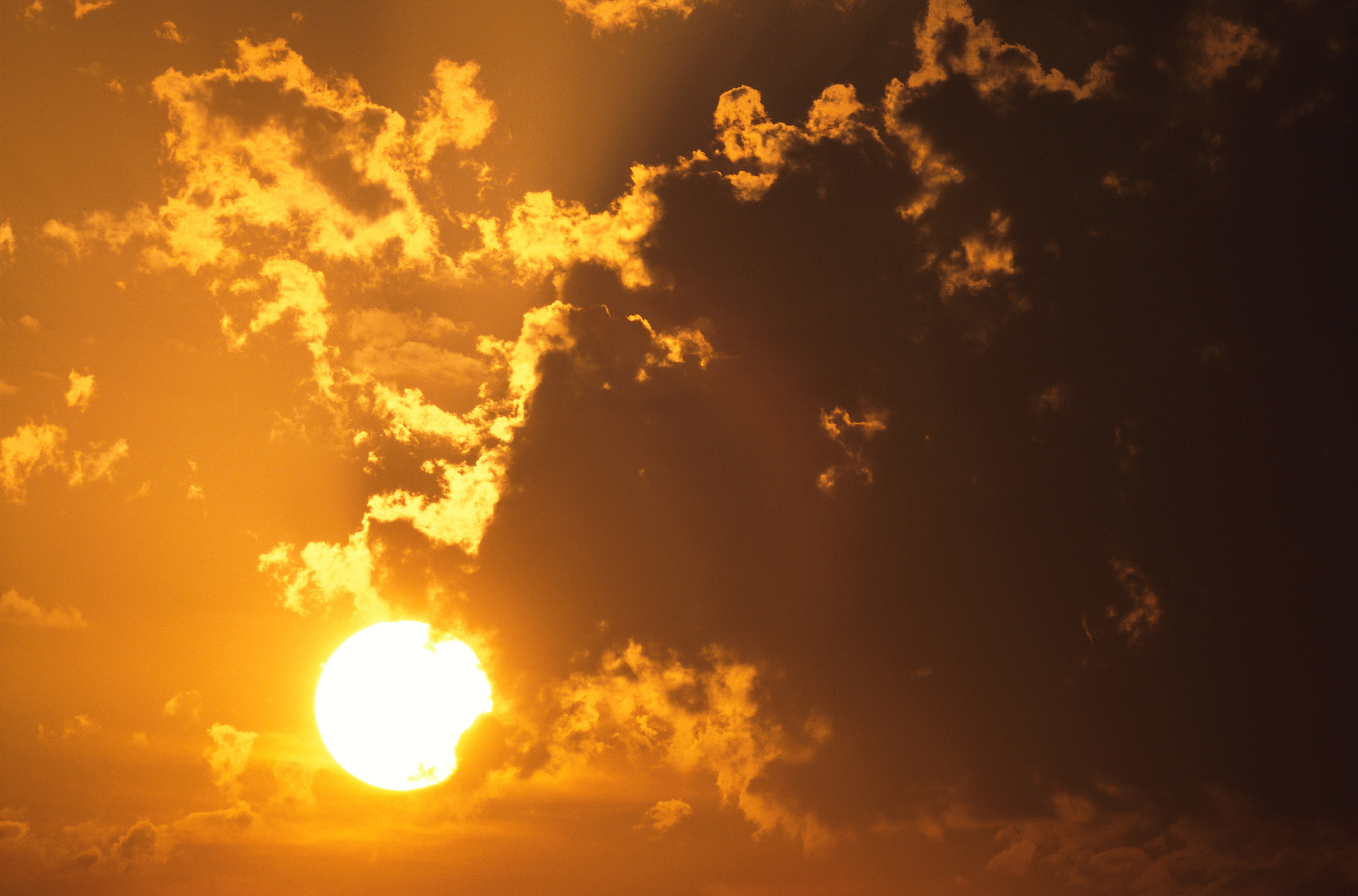  Sun shining through dark clouds