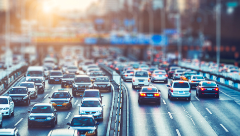 Stylized photo of traffic on a three-lane highway