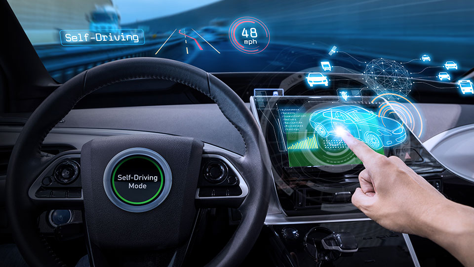 Interior of high-tech car with self-driving mode displayed.