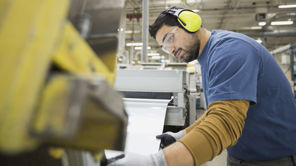 Manufacturing employee working with advanced technology.