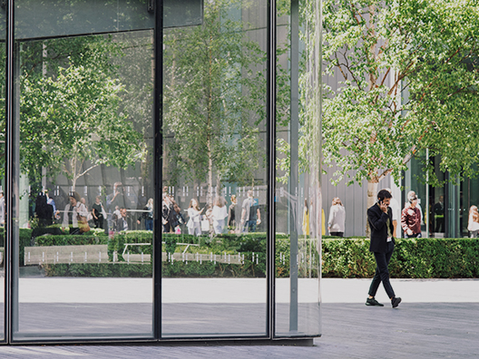 A businessperson takes a phone call outside.