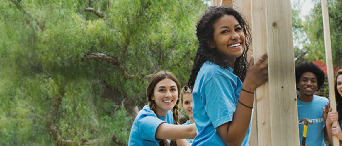 Young adults volunteer to build a home.