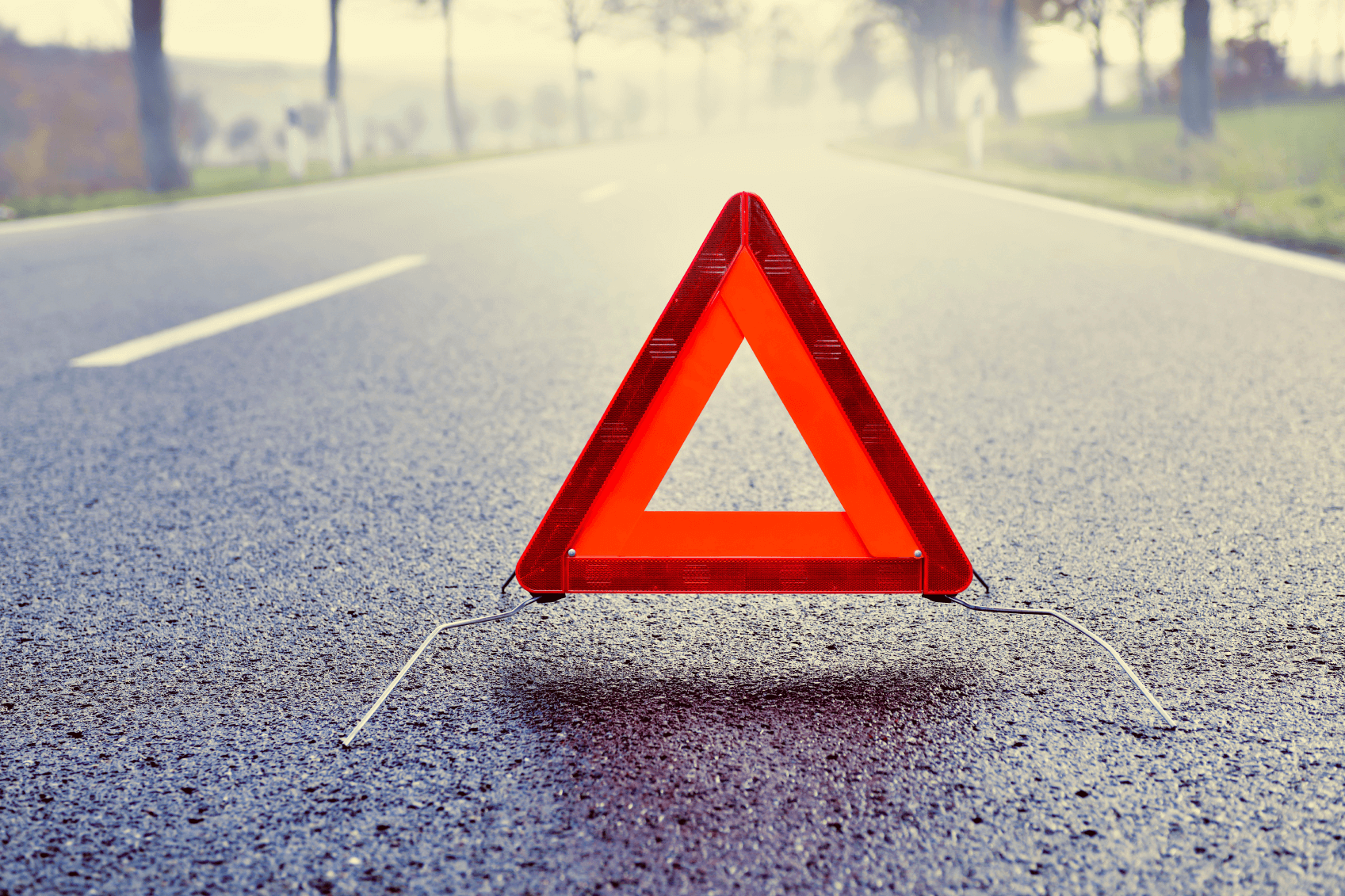 Warning Triangle on a Misty Road