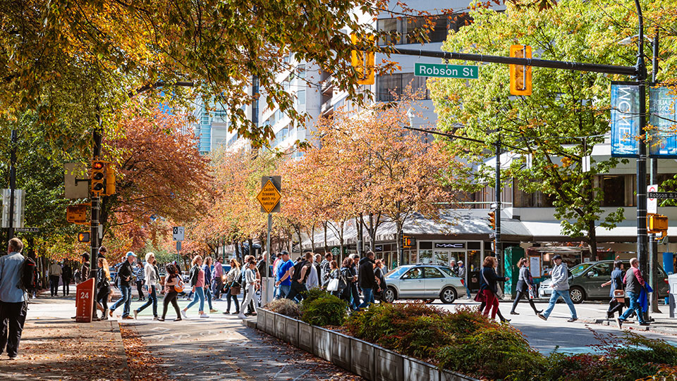 People walking in small town shopping district.