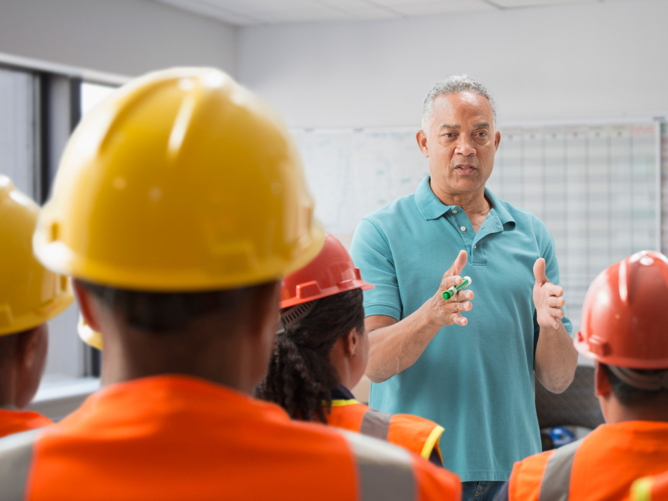 Speaker giving presentation to construction workers