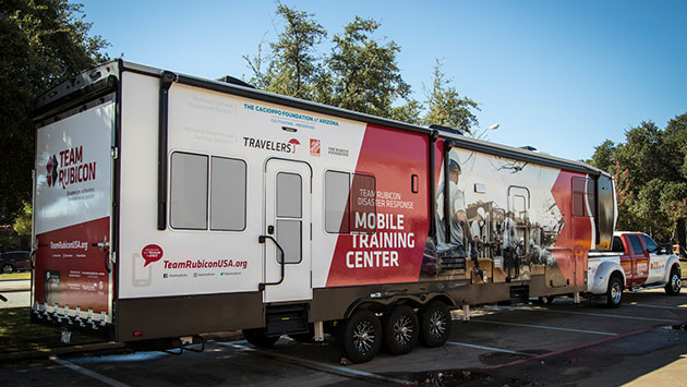 Team Rubicon mobile training center truck parked in a parking lot.