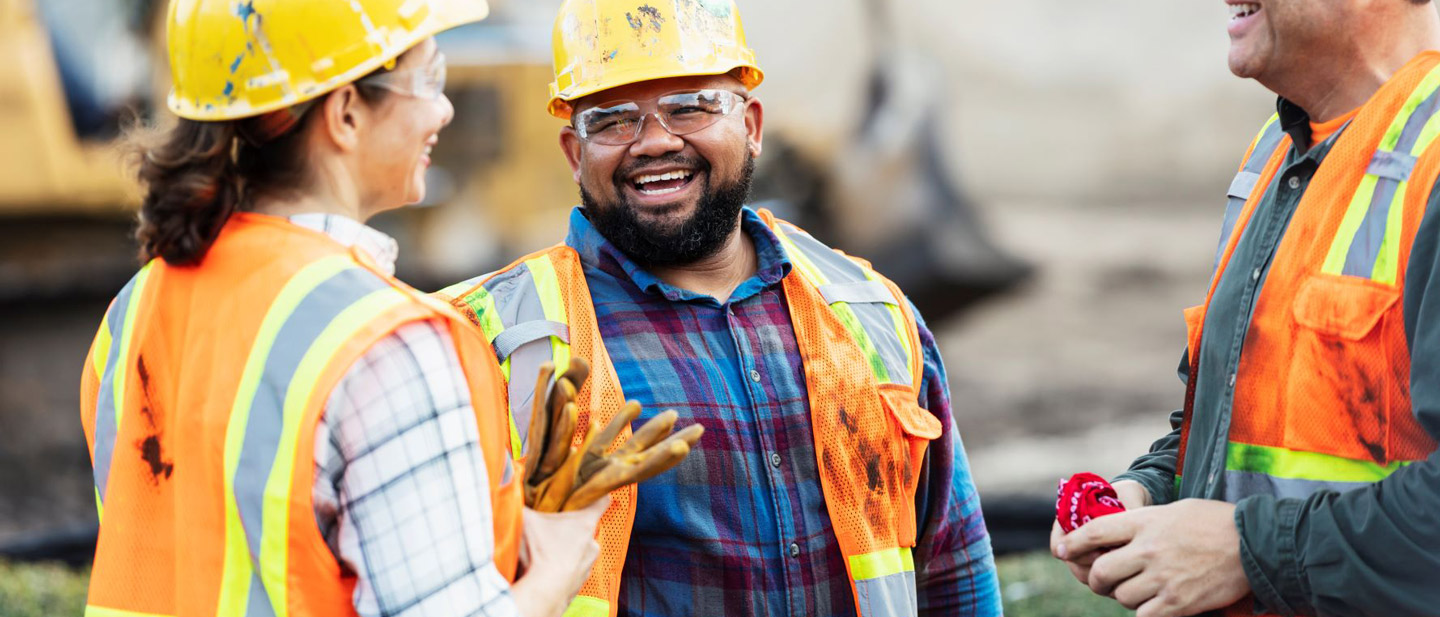 Three multi-ethnic construction workers chatting