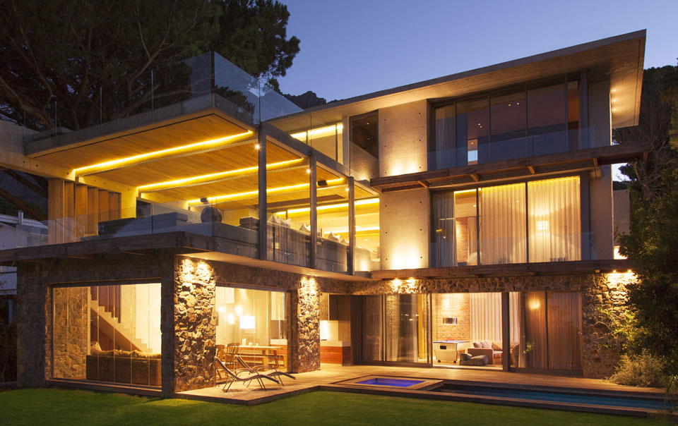 Modern house exterior illuminated at night.