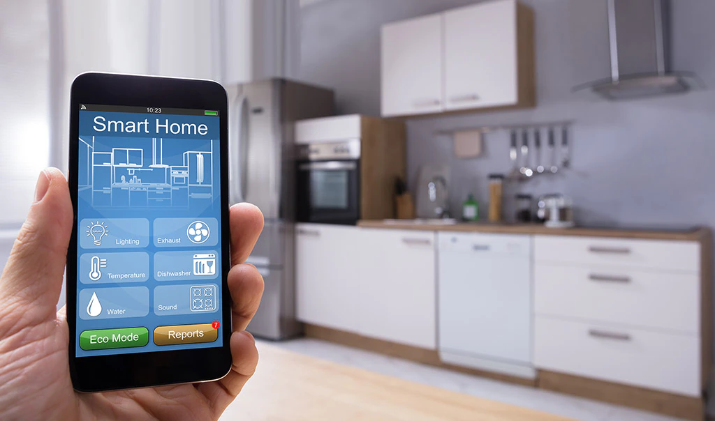 A hand holding a smart home device for detecting leaks.