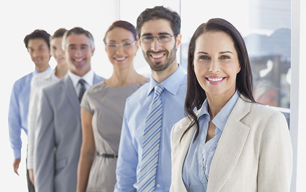 A line on six career professionals smiling before camera