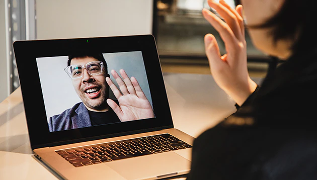 A woman being interviewed over an online meeting.