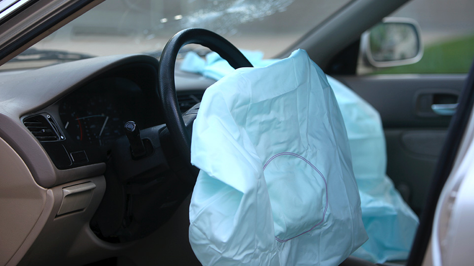 An airbag that has been deployed inside a car.