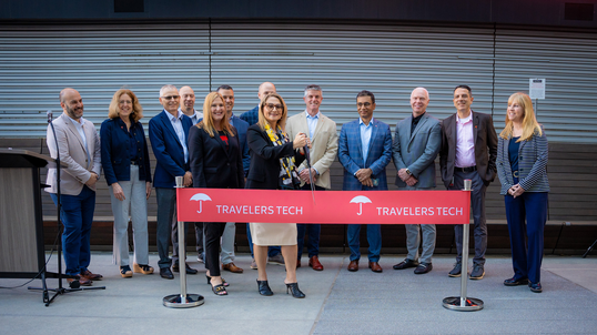 Cutting a ribbon to open the new Travelers Technology Hub in Atlanta, GA.