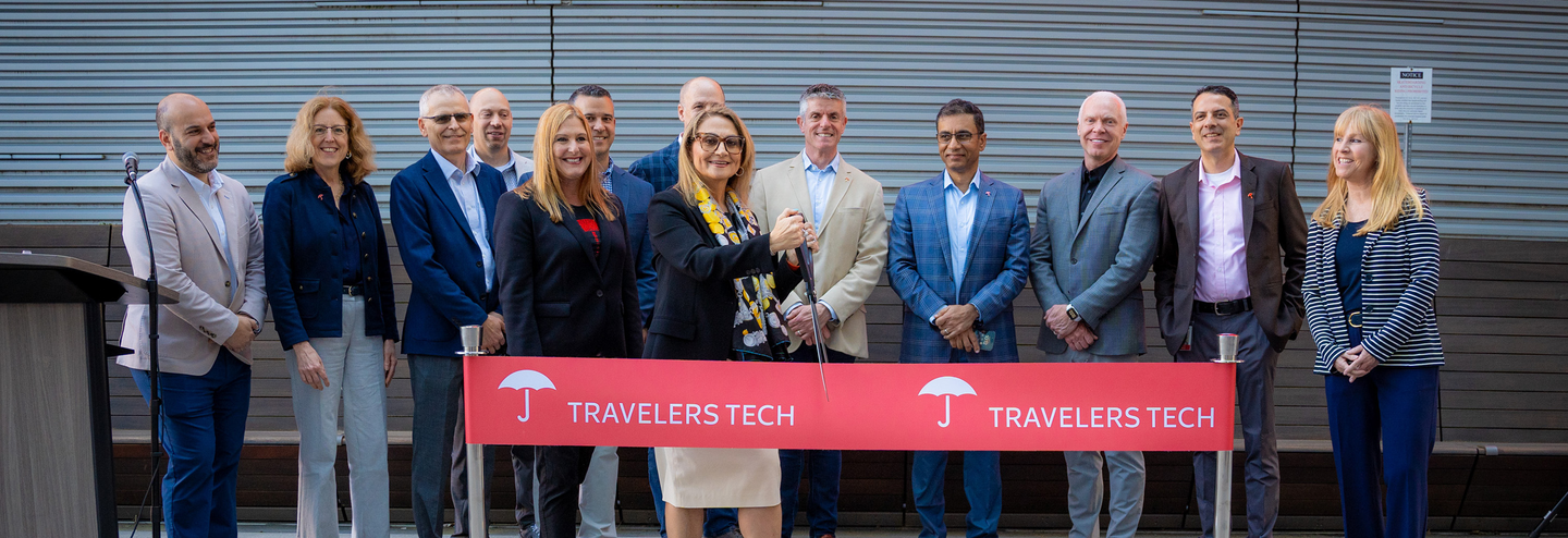 Cutting a ribbon to open the new Travelers Technology Hub in Atlanta, GA.