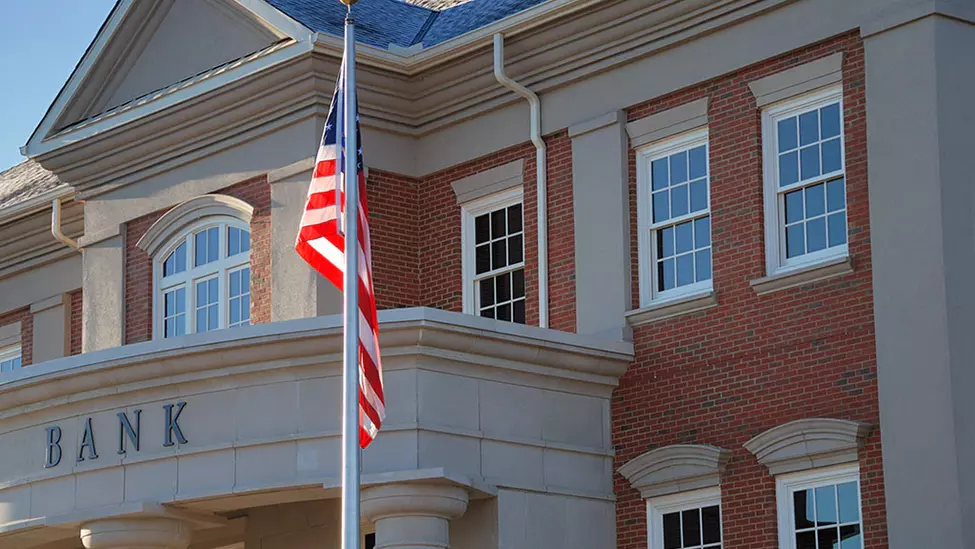 Bank with USA flag in front.