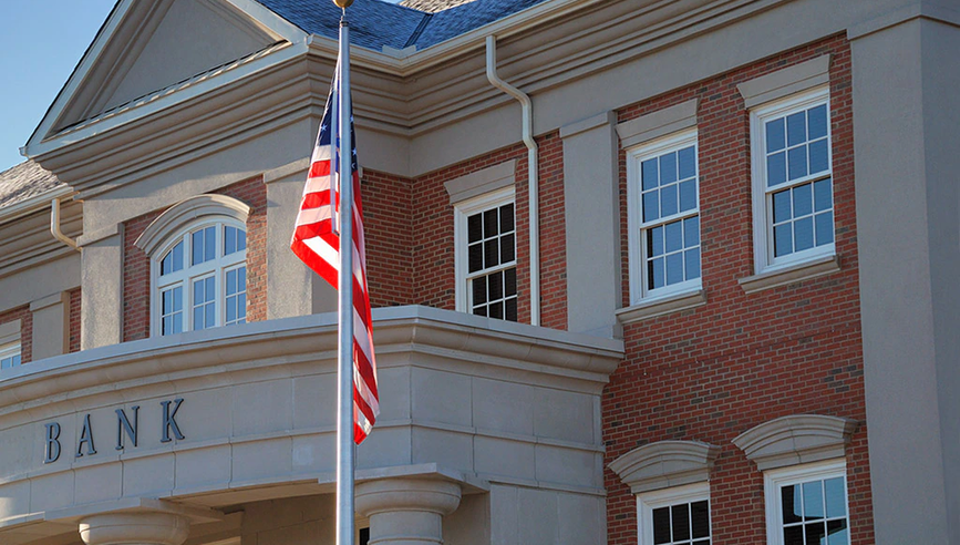 Bank with USA flag in front.