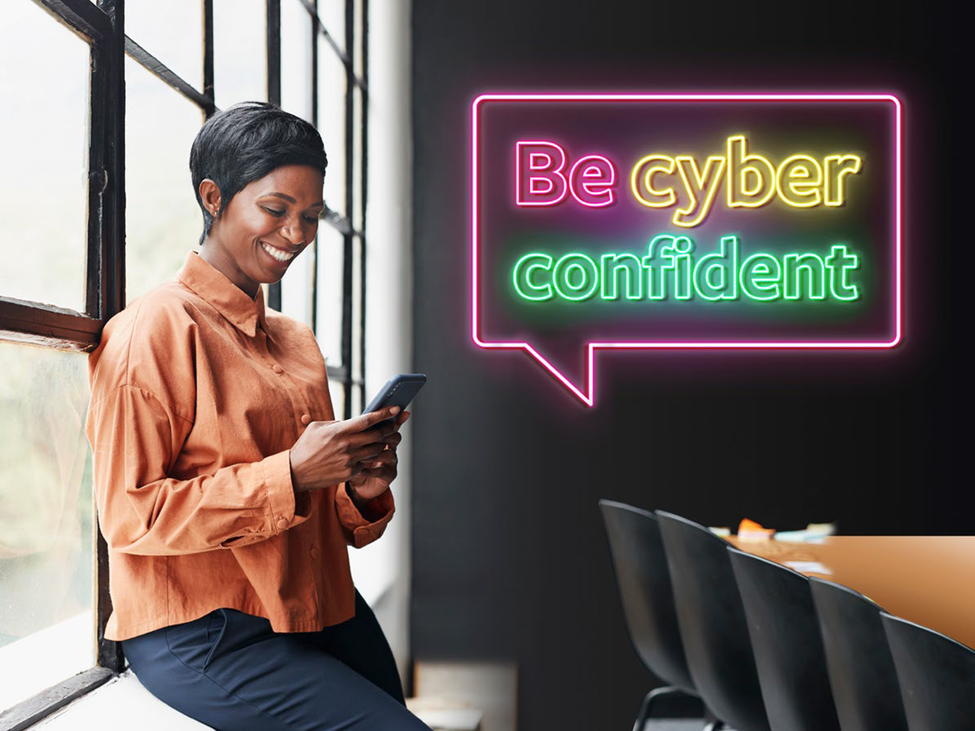 Smiling woman using her phone in a meeting room.