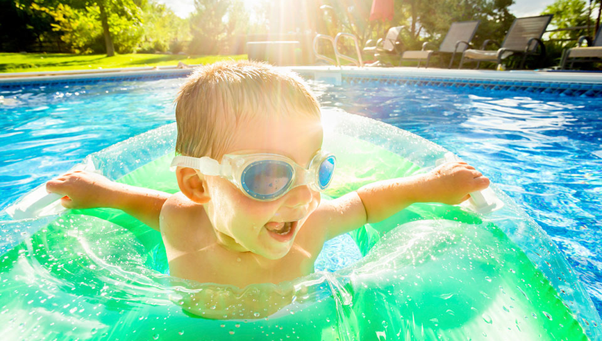 Young boy swimming in pool