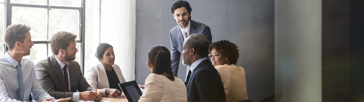 A group of business men and women in a conference room.