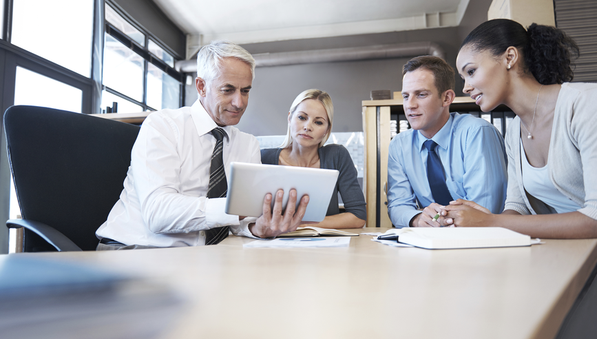 People in a meeting looking at a document.