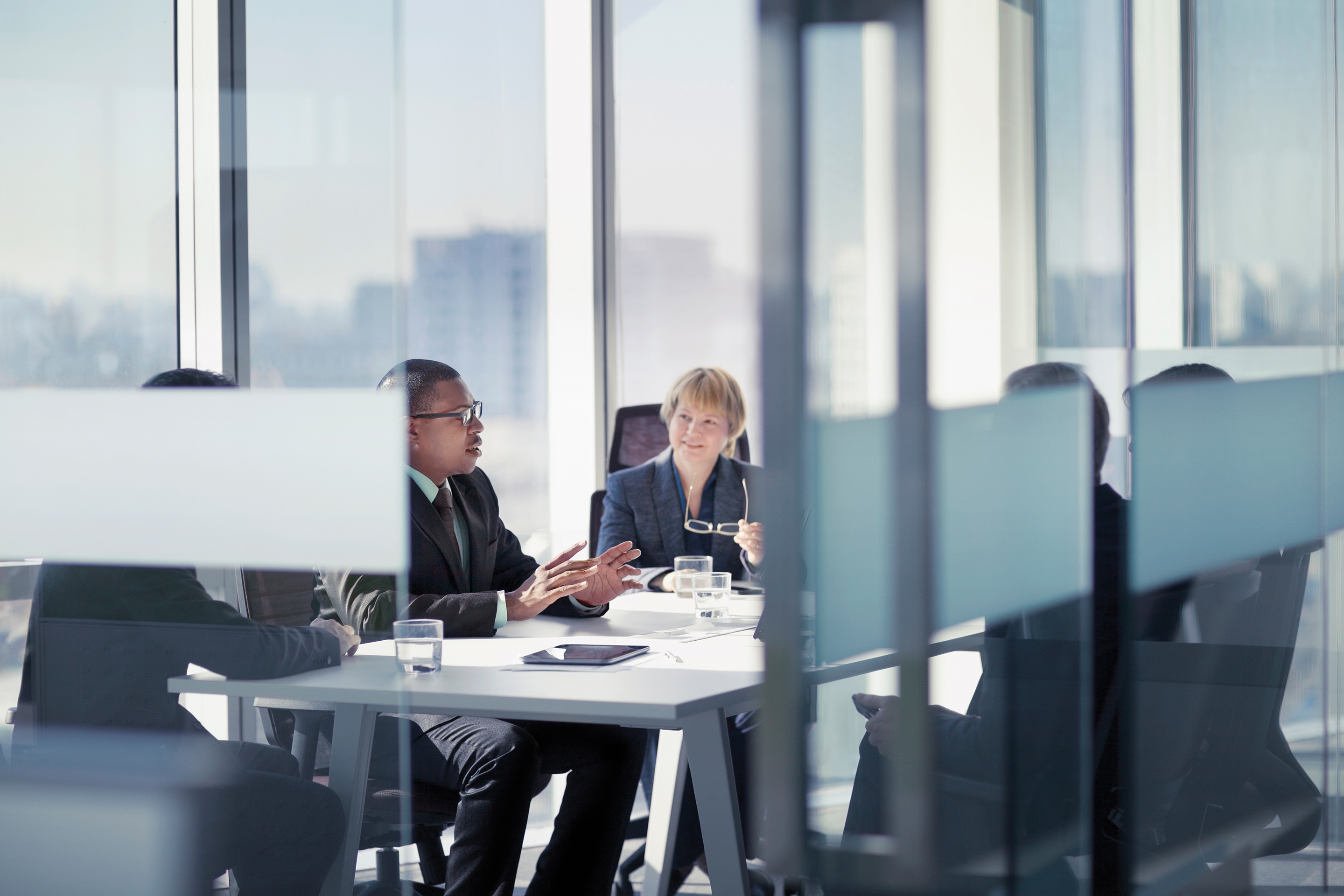 Business professionals having a meeting around a table at an office.