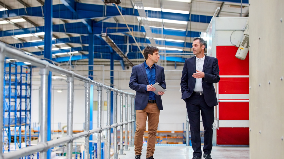 Specialist points to an area on an industrial building.