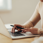 An insurance agent looking for online forms on a laptop computer.