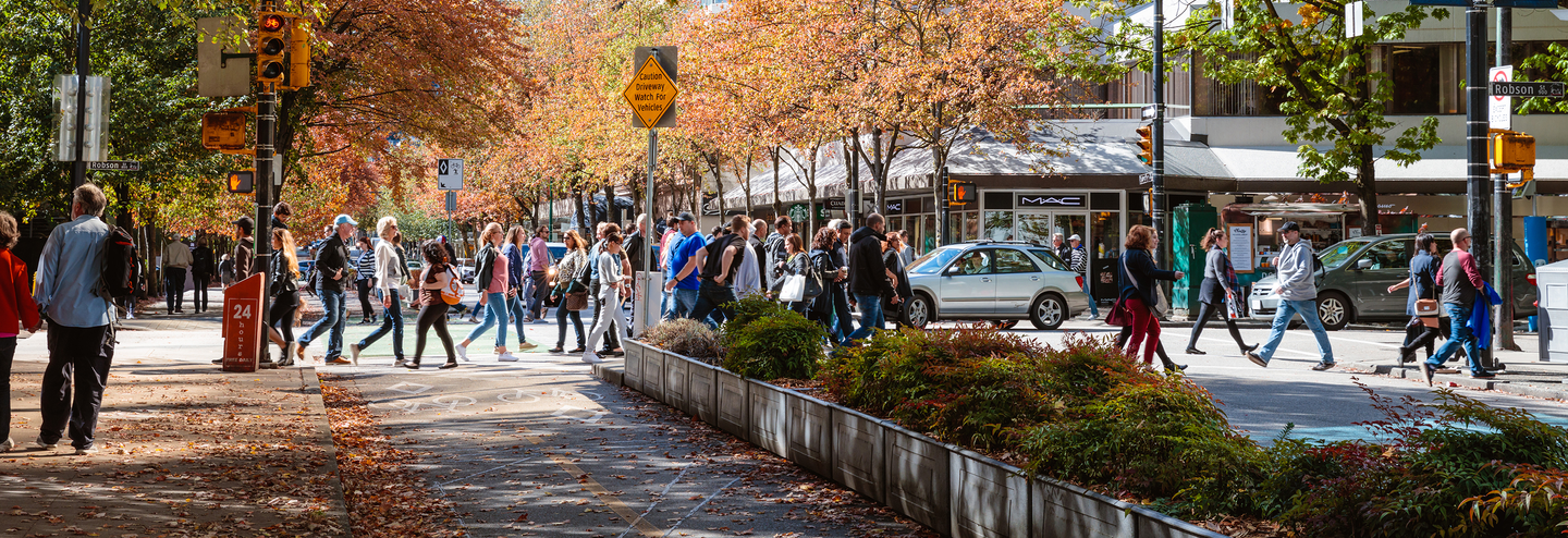 People walking in small town shopping district.