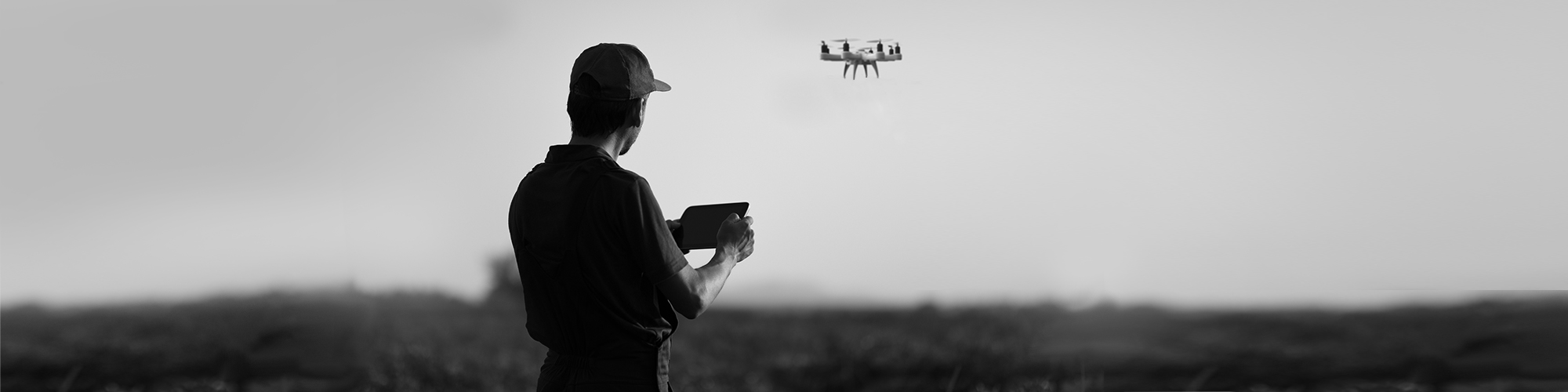 Person flying drone in a field.