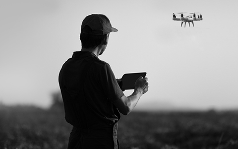 Person using a remote control to fly a drone