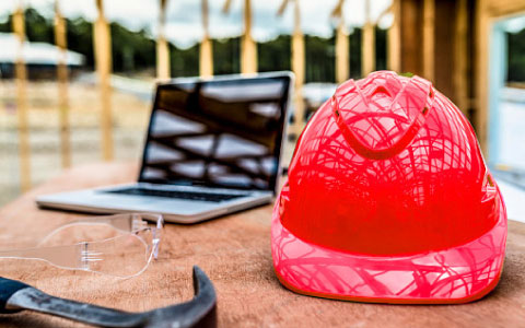 construction laptop on a table next to a laptop computer