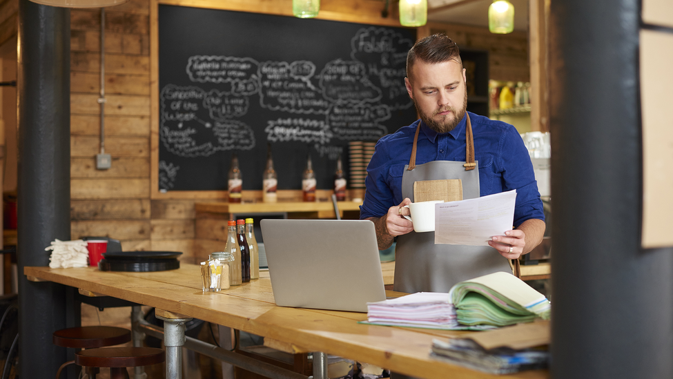 Small business owner looking at computer.