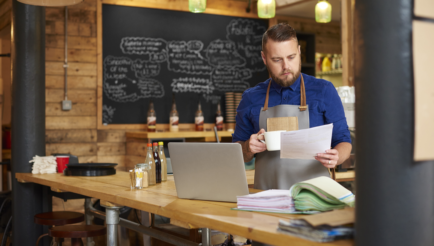 coffee shop owner with laptop