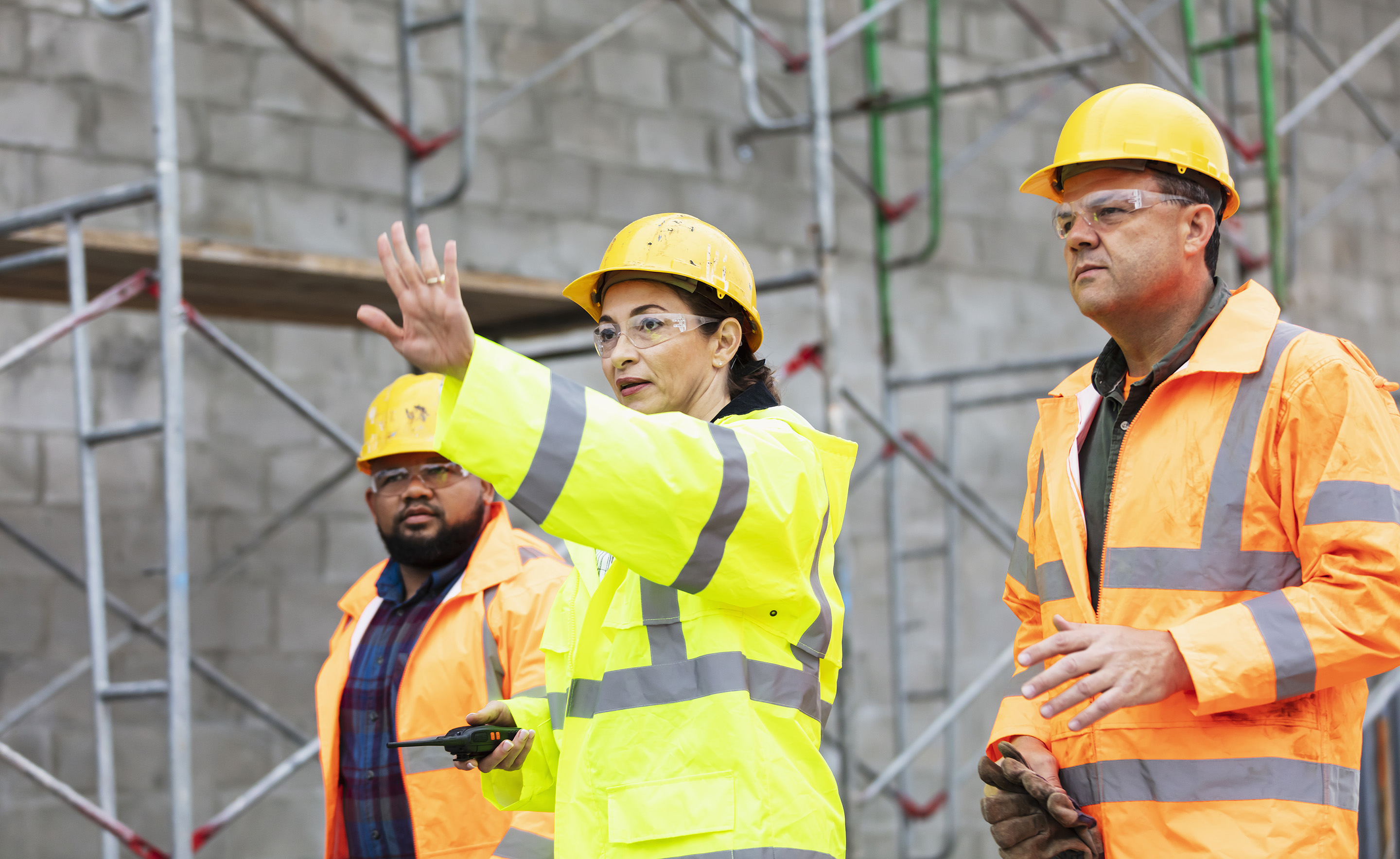 A construction manager with her crew surveying a job site.