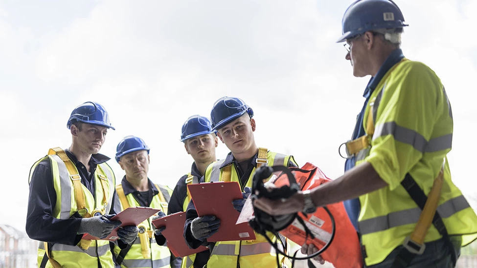 Construction new hires attending orientation at a job site.