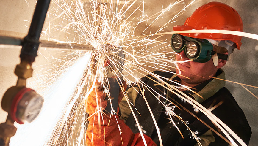 Construction worker welding as part of hot work operations.