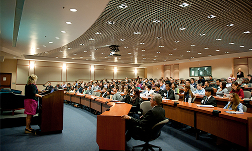 Woman introduces the national debt documentary, Overdraft, to a classroom of students