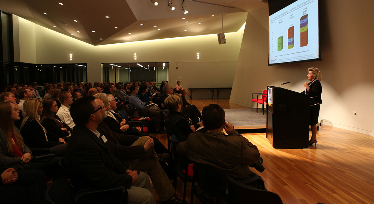 Travelers Institute President Joan Woodward discusses projected federal spending in front of a crowd